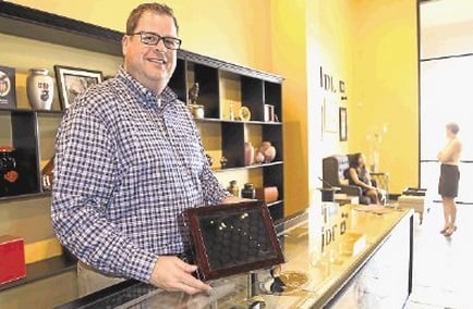 Founder of Distinctive Life Funeral & Cremations Jeff Friedman poses at one of his celebration of life boutiques.